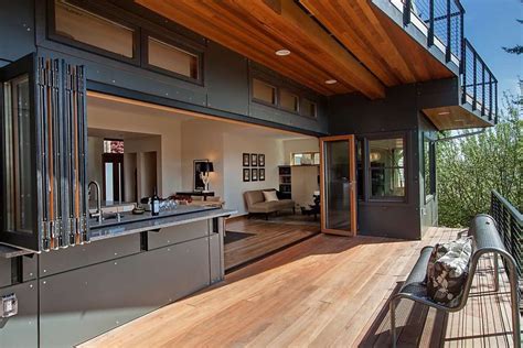 When recessed, doors and windows by NanaWall integrate this kitchen with the home's deck. Photo ...