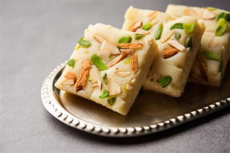 Premium Photo | Milk powder barfi also known as mava burfi white khoya ...