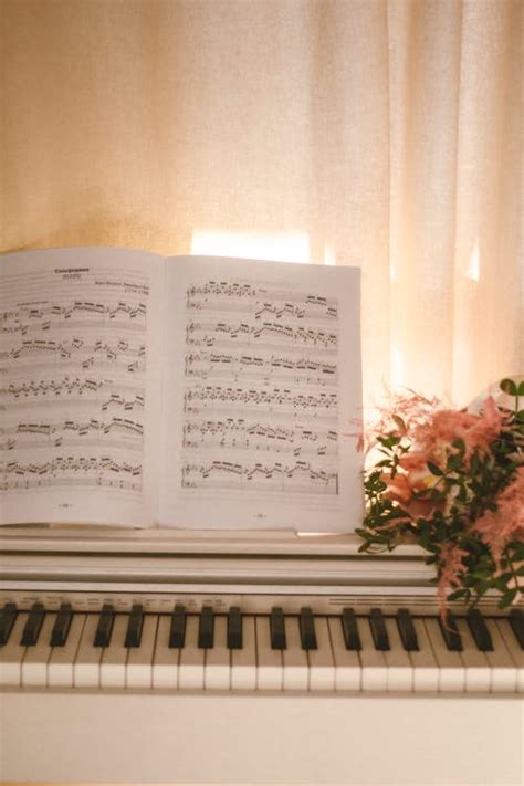 A piano with flowers and a sheet of music · Free Stock Photo