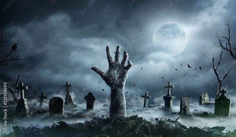 Zombie Hand Rising Out Of A Graveyard In Spooky Night Stock Photo | Adobe Stock