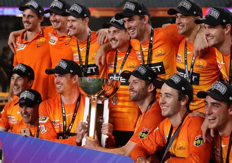 The Perth Scorchers players pose with the winners' trophy ...