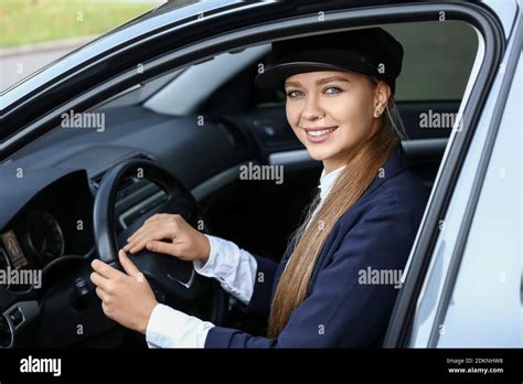 Beautiful chauffeur driving luxury car Stock Photo - Alamy