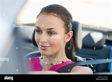 Young woman driving a convertible car Stock Photo - Alamy