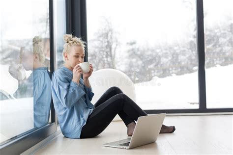 Woman Drinking Coffee and Using Laptop at Home Stock Image - Image of handsome, color: 102747381