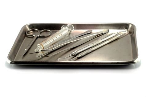 Premium Photo | Dental instrument set in stainless tray