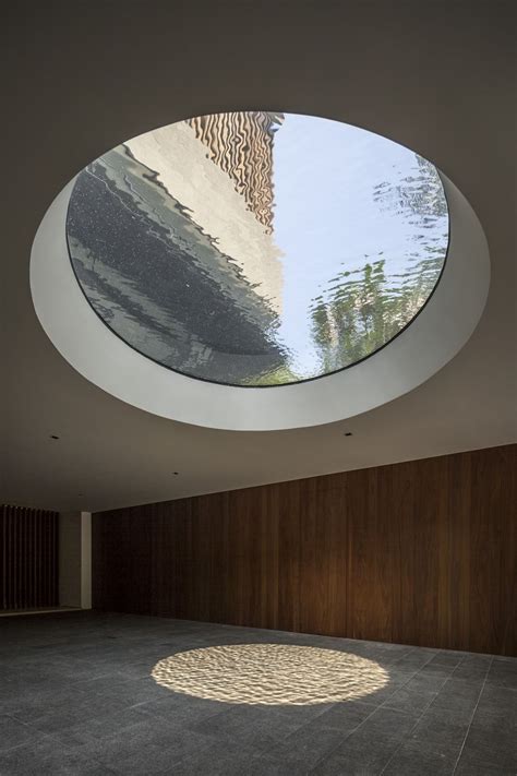 Round skylight above the driveway in modern mansion designed by Wallflower Architecture and ...