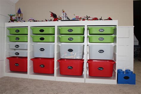 the shelves are filled with many different colored bins and toy cars on ...