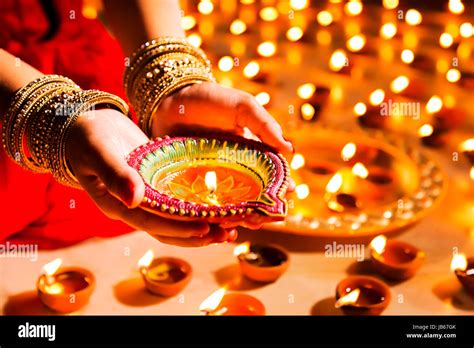 Traditional Indian woman lighting Diya Diwali Festival Stock Photo - Alamy