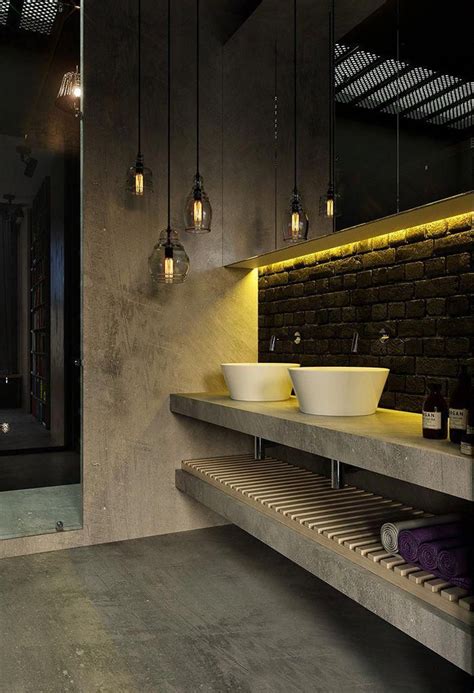 a bathroom with two sinks and hanging lights