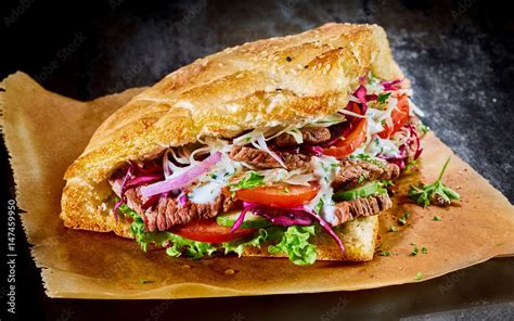Turkish doner kebab on golden toasted pita bread Stock Photo | Adobe Stock