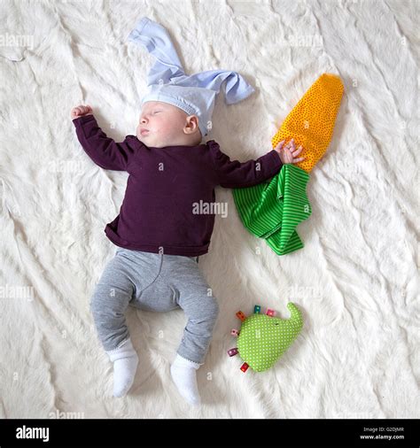 4 Month old Baby girl dressed as rabbit with carrots Stock Photo - Alamy