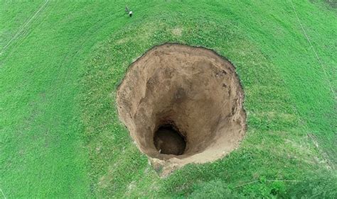 'GATE TO HELL' Terrified locals FRANTIC as giant hole appears in field | World | News | Express ...