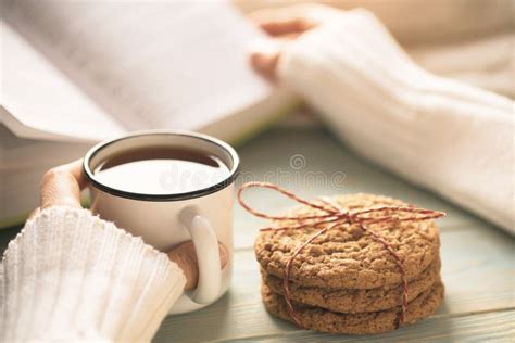 Girl Reading Book And Drinking Tea In Winter Stock Photo - Image of cookie, morning: 105541992