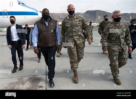 Secretary of Defense Lloyd J. Austin III walks with the commander of ...