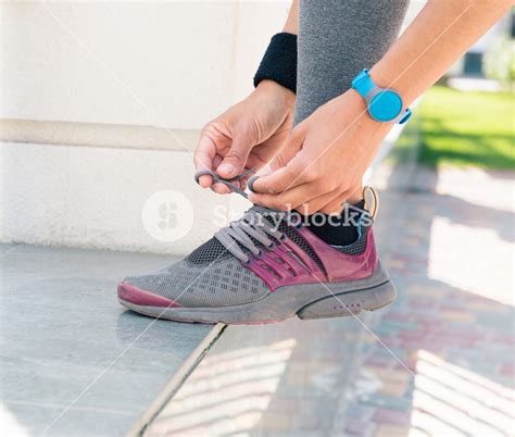 Female hands tying shoelaces Royalty-Free Stock Image - Storyblocks