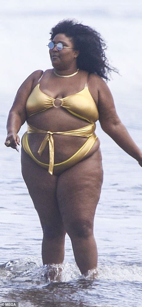 Lizzo flies the flag for body positivity as she hits the beach in gold ...