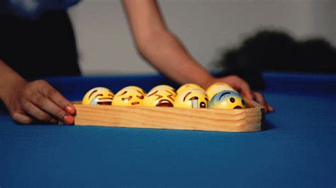 emoji-painted billiard balls take on playful personalities in the 'poolmoji' set