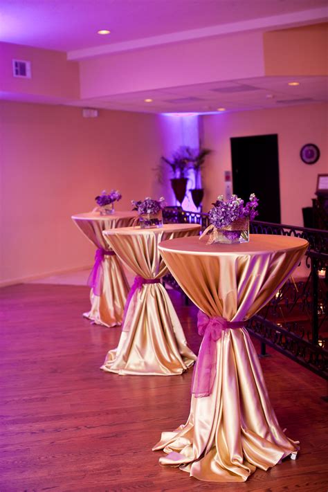 Cocktail tables with gold satin linens and purple organza sashes for ...