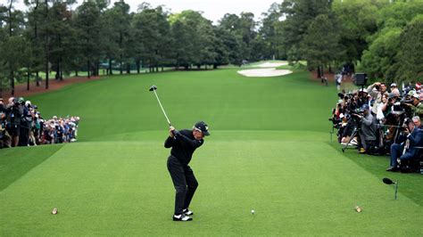 Masters champion and honorary starter Gary Player of South Africa plays a stroke from the No. 1 ...