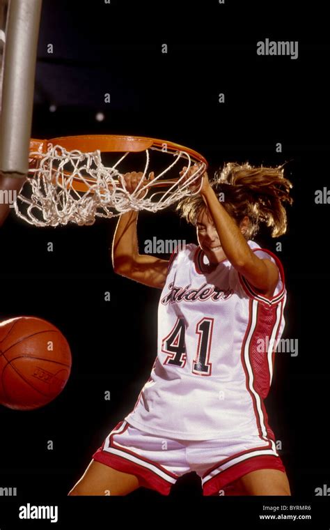 Female basketball player slam dunking Stock Photo - Alamy