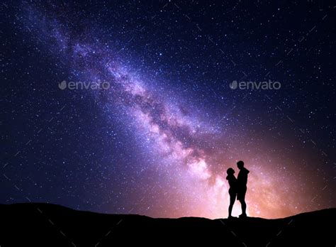 Milky Way with silhouette of people. Landscape with night sky Stock Photo by den-belitsky