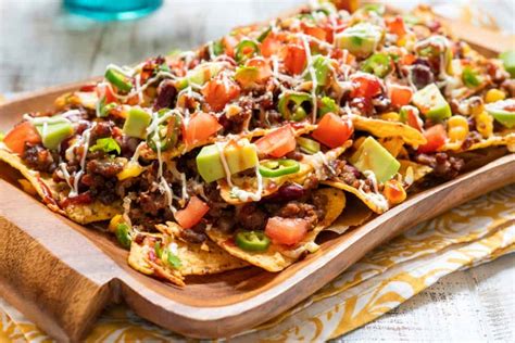 Nacho corn tortilla chips with cheese, meat, guacamole and red hot spicy salsa - Clean Eating ...