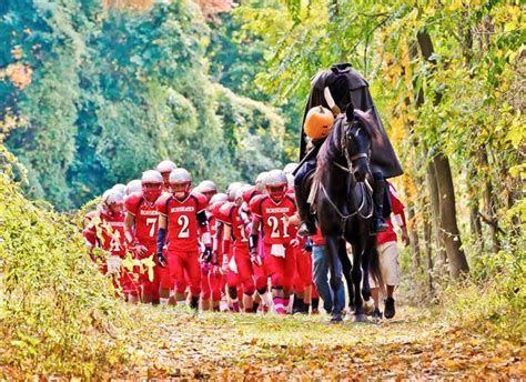 The Headless Horseman, the team mascot for Sleepy Hollow High in New York, leads football ...