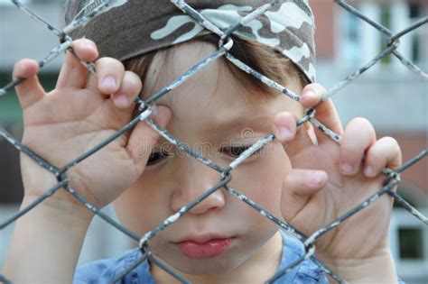 Sad boy behind bars stock image. Image of expression - 42123131