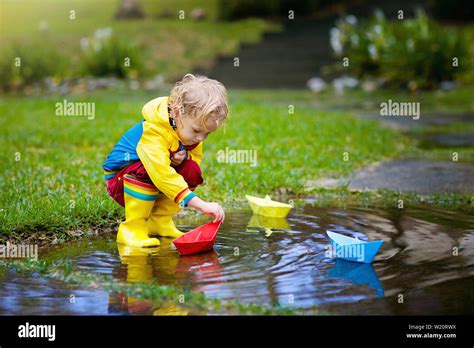 Kids Playing In Rain High Resolution Stock Photography and Images - Alamy