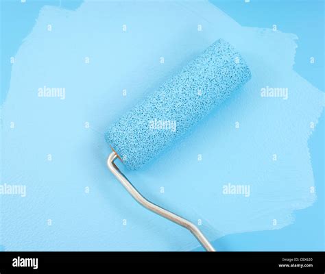 Paint roller and blue paint Stock Photo - Alamy