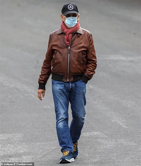 Steven Spielberg wears a mask as he goes for a stroll with Kate Capshaw ...