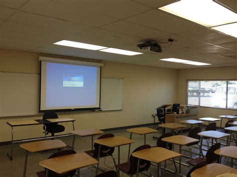 A HITACHI Classroom series projector mounted to the ceiling in a ...