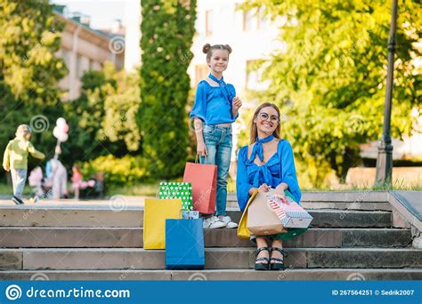 Young Mother and Her Daughter Doing Shopping Together. Woman with Girl Child after Shopping in ...