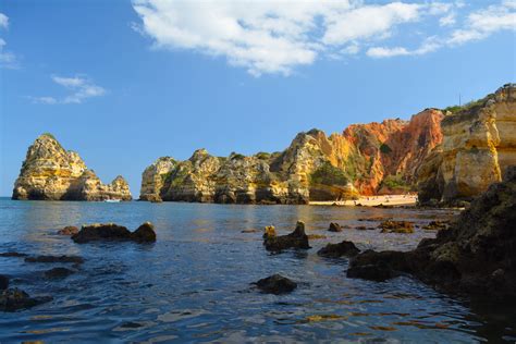Lagos, Portugal is known for its beautiful rock formations along the ...