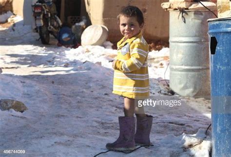 A Syrian child stands in the snow in the Arsal refugee camp in the... News Photo - Getty Images