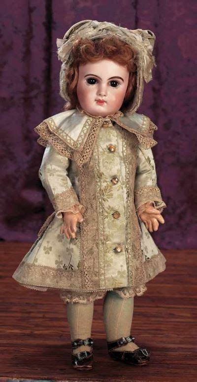 an antique doll is standing on a wooden table