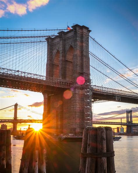 Sunrise First light in Brooklyn Bridge New York with lens flare and manhattan bridge in the ...