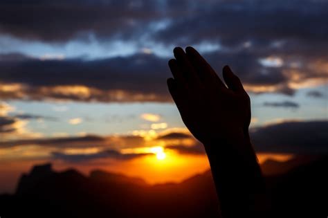 Premium Photo | Praying hands on sunset background. Black silhouette