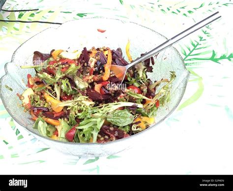 Bowl of vegan salad with the spoon Stock Photo - Alamy