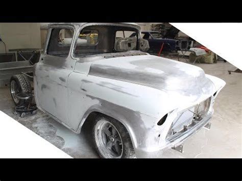 an old truck is being worked on in a garage with the hood up and it's ...