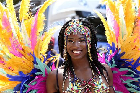 Notting Hill Carnival revellers strut their stuff in sequinned Caribbean costumes for day two ...