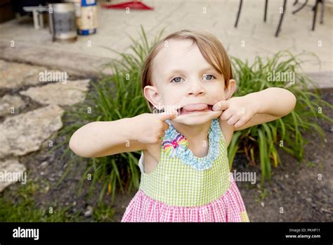 little girl playing and making funny faces Stock Photo - Alamy