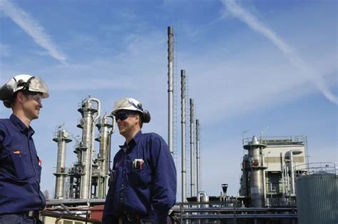 Oil and gas workers inside refinery industry Stock Photo by ©lagereek 104466846