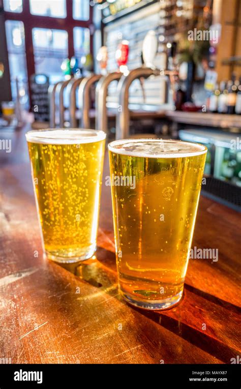 Close up of two pints of lager on the bar of a pub, UK, London Stock Photo - Alamy