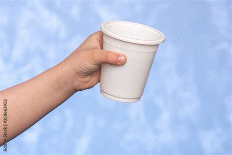 biodegradable disposable cup in a male hand. corn starch dishes ...