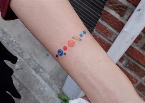 Solar system tattoo on the left inner forearm.