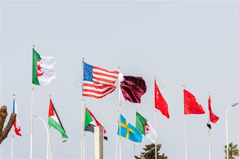 A Row of National Flags of Several Countries Waving Against a Clean Blue Sky. Close Up. Stock ...