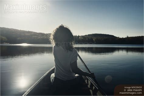 Photo of Woman canoeing on a lake | Stock Image MXI28433