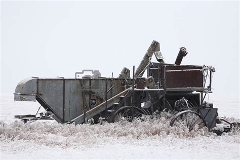 Abandoned antique threshing machine in winter by pictureguy Vectors & Illustrations with ...