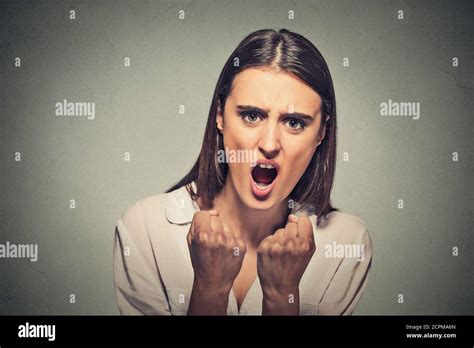 Closeup portrait angry frustrated woman screaming isolated on gray wall ...